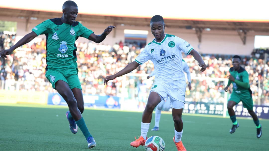 Nsingizini’s Quality Dlamini in control of the ball while Green Mamba's Njabulo Magagula closes in.